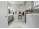 Bright main bath featuring dual sinks, a tile backsplash, and a glass enclosed shower at 5233 N 207Th Dr, Buckeye, AZ 85396
