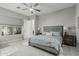 Comfortable main bedroom featuring a ceiling fan, area rug, and ensuite bath access at 5233 N 207Th Dr, Buckeye, AZ 85396