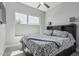 Comfortable bedroom with a large window, contemporary lighting, and neutral decor at 5233 N 207Th Dr, Buckeye, AZ 85396