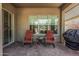 Inviting outdoor patio with comfortable seating and a sliding door entrance at 5233 N 207Th Dr, Buckeye, AZ 85396