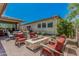Relaxing outdoor patio featuring a stone fire pit and comfortable seating area at 5233 N 207Th Dr, Buckeye, AZ 85396