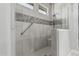 Luxurious walk-in shower with custom tile, and multiple showerheads at 5233 N 207Th Dr, Buckeye, AZ 85396