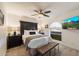 Comfortable bedroom with a ceiling fan, arched window, and stylish decor at 5334 E Everett Dr, Scottsdale, AZ 85254