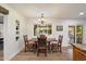 A cozy dining area bathed in natural light, complete with an elegant chandelier and backyard views at 5334 E Everett Dr, Scottsdale, AZ 85254