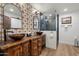 Well-lit bathroom featuring a custom vanity with vessel sinks, modern mirrors, and a glass enclosed shower at 5334 E Everett Dr, Scottsdale, AZ 85254