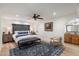 A large bedroom with a wooden headboard, ceiling fan and a vanity area visible through an archway at 5334 E Everett Dr, Scottsdale, AZ 85254