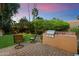 Backyard with built-in outdoor kitchen and seating area at 5334 E Everett Dr, Scottsdale, AZ 85254