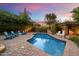 Backyard pool with lounge chairs and lush greenery, ideal for relaxation at 5334 E Everett Dr, Scottsdale, AZ 85254