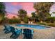 Inviting backyard pool area with lounge chairs and lush landscaping at 5334 E Everett Dr, Scottsdale, AZ 85254