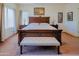 A lovely bedroom with a large bed and tufted bench, illuminated by natural light at 5425 W Harwell Rd, Laveen, AZ 85339