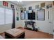Cozy bedroom features fan, guitar, ottoman, and decoratively framed artwork at 5425 W Harwell Rd, Laveen, AZ 85339
