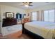 A cozy bedroom with dark furniture, carpet and a relaxing atmosphere at 5425 W Harwell Rd, Laveen, AZ 85339