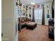 Comfortable bedroom with guitars, fan, couch, ottoman, and neutral carpeting at 5425 W Harwell Rd, Laveen, AZ 85339