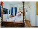 Comfortable bedroom featuring a four-poster bed, TV, and soft lighting at 5425 W Harwell Rd, Laveen, AZ 85339