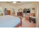 Bright primary bedroom offering a ceiling fan, TV, recliner, and adjoining bathroom at 5425 W Harwell Rd, Laveen, AZ 85339