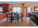 Comfortable dining area with table and chairs, adjacent to the living room and kitchen at 5425 W Harwell Rd, Laveen, AZ 85339