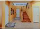 Inviting home foyer showcasing tile flooring, staircase, and natural light at 5425 W Harwell Rd, Laveen, AZ 85339