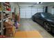 Spacious two-car garage with room for storage and a sleek black sports car at 5425 W Harwell Rd, Laveen, AZ 85339