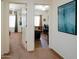 Open hallway view of bedrooms with ceiling fans and office with hard flooring at 5425 W Harwell Rd, Laveen, AZ 85339
