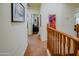 Upper hallway with artwork, connecting to a living area and bedroom at 5425 W Harwell Rd, Laveen, AZ 85339
