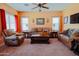 Cozy living room with comfortable leather seating, neutral walls, and ceiling fan at 5425 W Harwell Rd, Laveen, AZ 85339