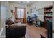 Bright office with hardwood floors, desk setup, and comfortable couch at 5425 W Harwell Rd, Laveen, AZ 85339