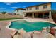 Backyard view featuring a refreshing pool with rock accents and a covered patio perfect for entertaining at 5425 W Harwell Rd, Laveen, AZ 85339