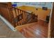Hardwood staircase with decorative railings, creating an elegant transition between floors at 5425 W Harwell Rd, Laveen, AZ 85339