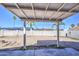 Backyard featuring a covered patio, concrete pad, block wall and desert landscaping at 646 W Grove Cir, Mesa, AZ 85210