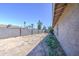 Sideyard with concrete block wall and sparse landscaping; great potential to customize at 646 W Grove Cir, Mesa, AZ 85210