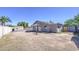 View of the spacious backyard, the rear of the house, detached shed, block fence and patio at 646 W Grove Cir, Mesa, AZ 85210
