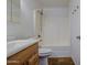 Well-lit bathroom with a wood vanity, shower, and toilet at 646 W Grove Cir, Mesa, AZ 85210