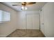 A cozy bedroom with neutral carpet, a window, and a closet with sliding doors at 646 W Grove Cir, Mesa, AZ 85210