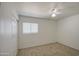 The carpeted bedroom includes a door to the outside, a window with blinds, and a ceiling fan at 646 W Grove Cir, Mesa, AZ 85210