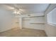 Bright carpeted bedroom featuring closet storage with built-in racks and a ceiling fan with a light fixture at 646 W Grove Cir, Mesa, AZ 85210