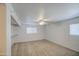 A simple bedroom with neutral carpet, white walls and ceiling fan with natural light coming through windows at 646 W Grove Cir, Mesa, AZ 85210