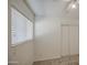 This carpeted bedroom features a window with blinds and a sliding closet door at 646 W Grove Cir, Mesa, AZ 85210