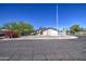 Street view of a single-story stucco home with desert landscaping and a clear blue sky at 646 W Grove Cir, Mesa, AZ 85210