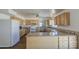 This kitchen boasts wood cabinets, granite countertops, a tile backsplash, and a bright, open design at 646 W Grove Cir, Mesa, AZ 85210