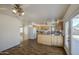 Bright, open kitchen with wood-look floors, granite countertops, island, and stainless steel appliances at 646 W Grove Cir, Mesa, AZ 85210