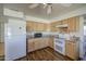 Updated kitchen features light wood cabinets, modern appliances, granite countertops, and mosaic backsplash at 646 W Grove Cir, Mesa, AZ 85210