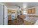 A well-lit kitchen features wood cabinets, granite countertops, tile backsplash, and stainless steel appliances at 646 W Grove Cir, Mesa, AZ 85210