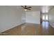 Open-concept living room with tile flooring, white walls, and a ceiling fan at 646 W Grove Cir, Mesa, AZ 85210