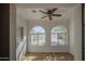 Bright sunroom with hardwood floors and large arched windows offering abundant natural light at 646 W Grove Cir, Mesa, AZ 85210