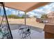 Backyard features a patio with chairs, a table, and a swing at 6836 W Bronco Trl, Peoria, AZ 85383