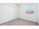 Neutral-toned bedroom with window and sliding double door closet at 6836 W Bronco Trl, Peoria, AZ 85383