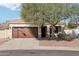 Charming single-story home features a two-car garage and mature landscaping at 6836 W Bronco Trl, Peoria, AZ 85383