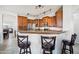Kitchen with bar seating, granite countertops, stainless steel appliances, and wood cabinetry at 6836 W Bronco Trl, Peoria, AZ 85383