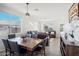 Open-concept floorplan, with dining area, and bright living room with large windows at 6836 W Bronco Trl, Peoria, AZ 85383