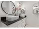 Modern bathroom featuring double sinks, black countertops and stylish vanity lighting at 7006 E Jensen St # 40, Mesa, AZ 85207
